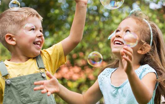 Kids blowing bubbles
